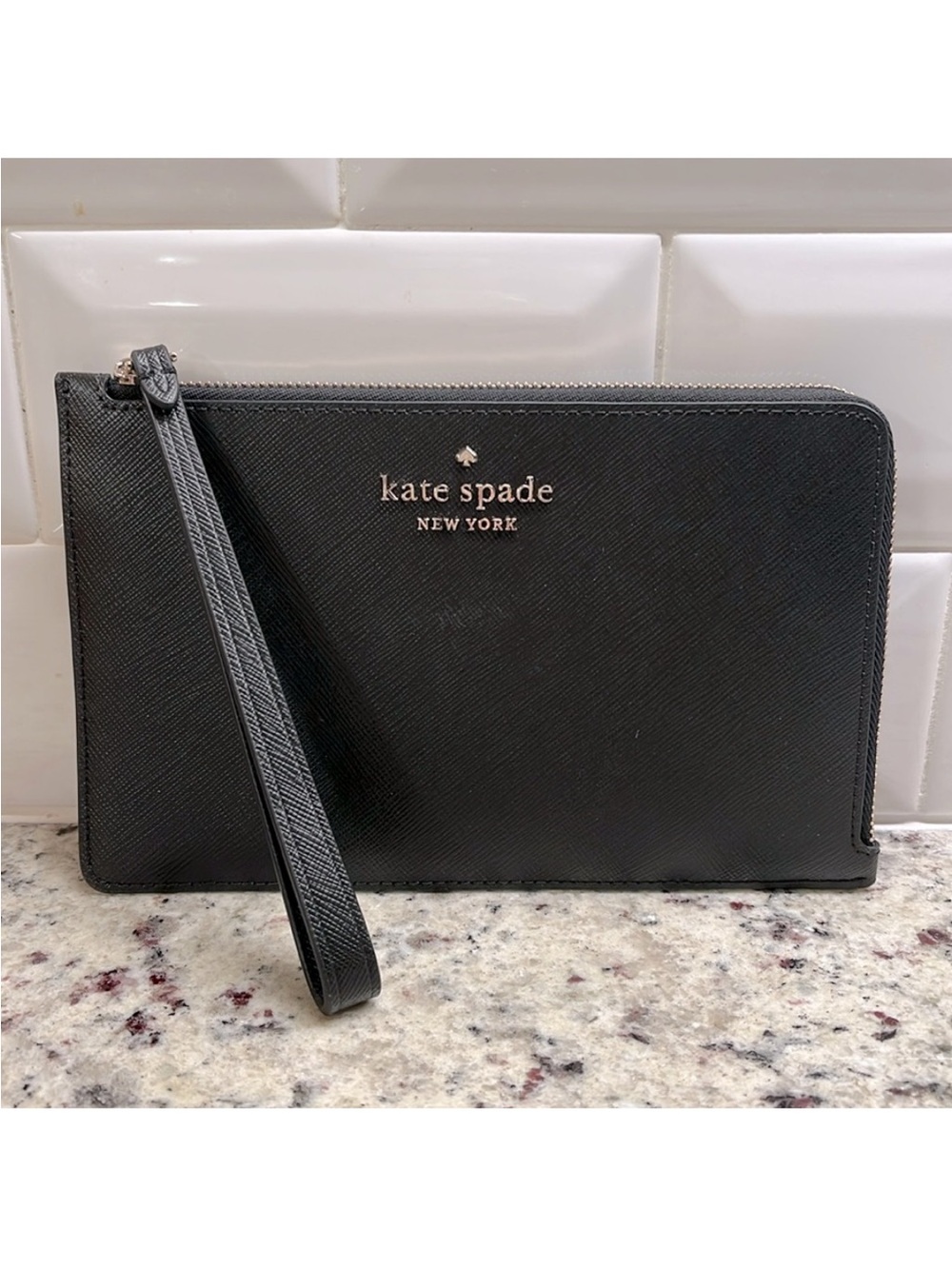 kate spade black saffiano wristlet clutch with gold logo